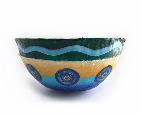 Experience the beauty of a peaceful shoreline with paper mache coastal bowls. Hand-painted using vibrant seaside color palette. Handmade with irregular and imperfect surface. Layered with paper and twine. Created using recycled and up-cycled materials. Lightweight, durable and vibrant. 9 "to 9 1/2" Diameter - 3 3/4" to 4 1/2" High Sealed inside and out for normal handling and use. For decorative use only - not for food use.  tribegift.com