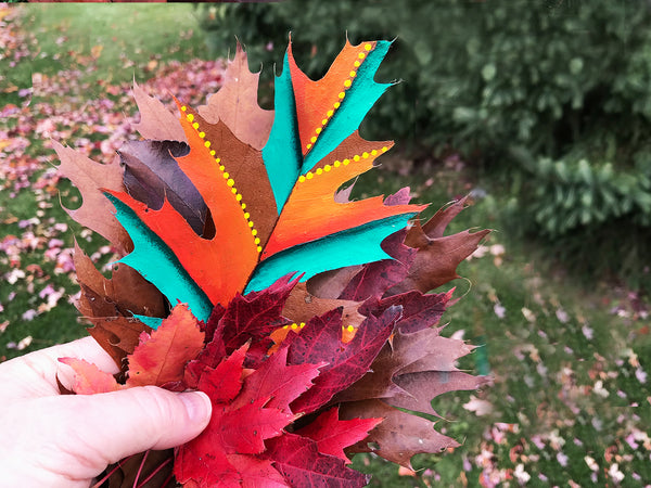 Turning dry leaves and acorns into unique eco gifts and home décor - most certainly an unusual canvas. Perfect gift for outdoor lovers! Red oak leaves collected from the floors of nature, pressed and then painted with vibrant color. Red oak acorns dried, cupule reconnected and then painted with vibrant colors. Like fingerprints, each leaf and acorn are unique. A unique one-of-a-kind nature gift for that special someone or yourself. This is most certainly nature inspired artwork!  tribegift.com